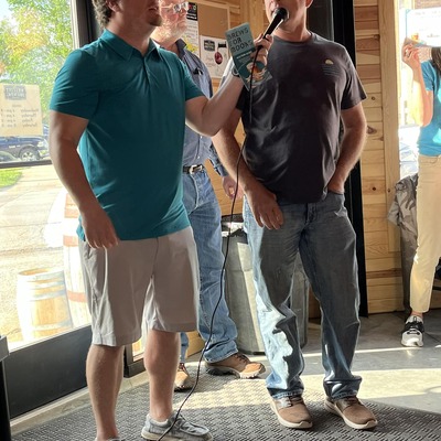 MC Jake Spalding and Live Auction Donor Mark Aeschliman at Brews for Books 2024