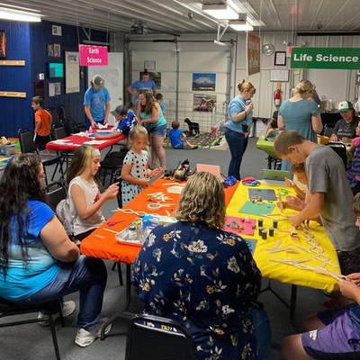 Summer programs engage kids with science activities in open-exploration sessions & group sessions.