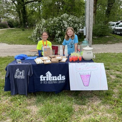 Local students selling lemonade at Beck Bookman Library's party in the yard.